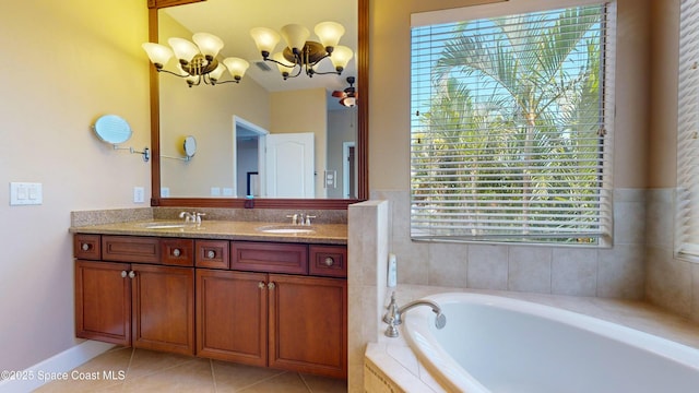 full bath with tile patterned flooring, a garden tub, a sink, and double vanity