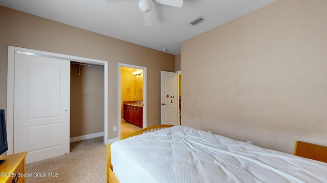 bedroom featuring light carpet, baseboards, visible vents, ceiling fan, and a closet