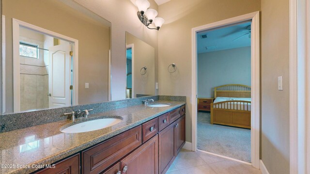 bathroom featuring ensuite bathroom, double vanity, tile patterned flooring, and a sink