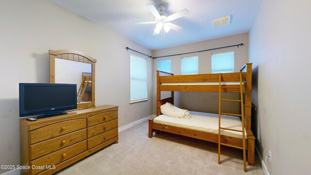 bedroom with carpet floors, visible vents, ceiling fan, and baseboards