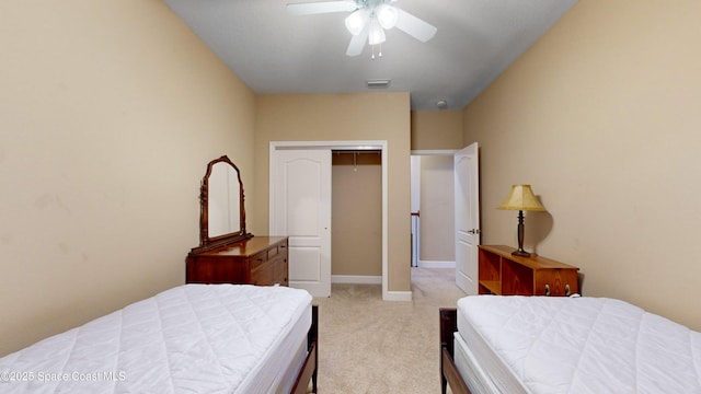 bedroom featuring light colored carpet, visible vents, baseboards, a ceiling fan, and a closet