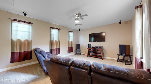 living area featuring ceiling fan, light carpet, visible vents, and baseboards