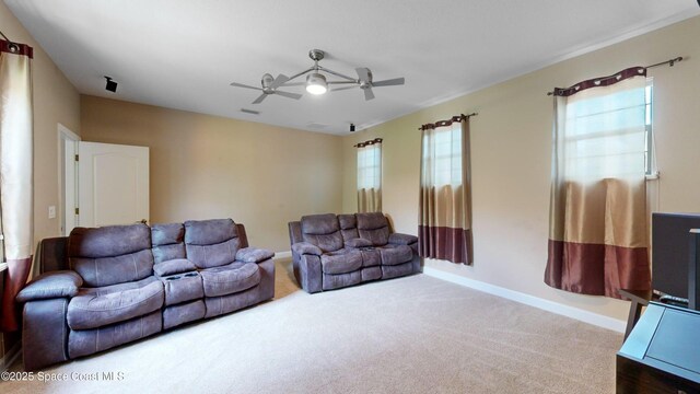 living room with ceiling fan, plenty of natural light, carpet flooring, and visible vents