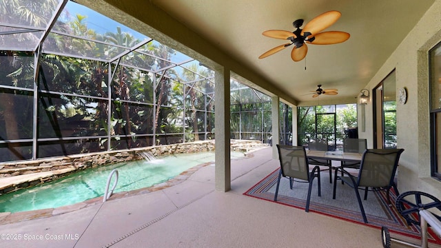 exterior space featuring ceiling fan, a patio, outdoor dining space, and glass enclosure