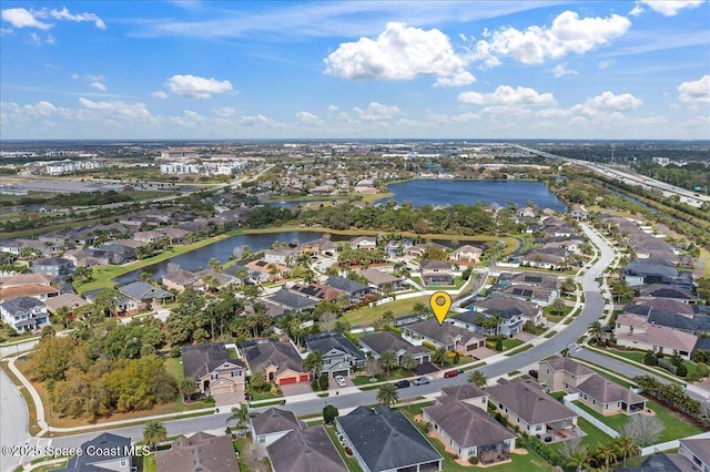 drone / aerial view featuring a water view and a residential view