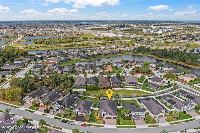 drone / aerial view with a water view and a residential view