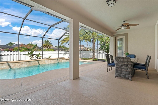 view of swimming pool with glass enclosure, fence, a ceiling fan, a fenced in pool, and a patio area