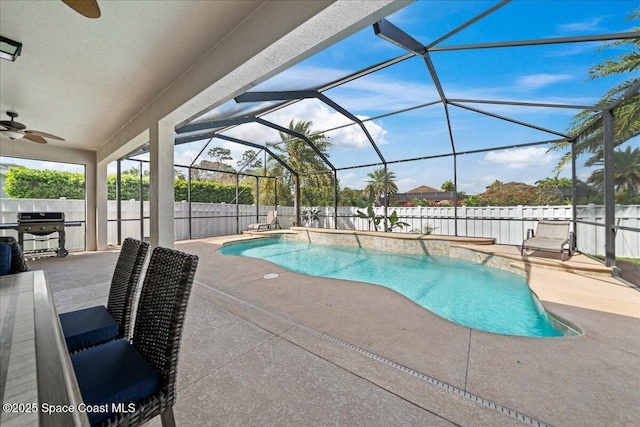 view of swimming pool with a patio area, a fenced backyard, and a ceiling fan