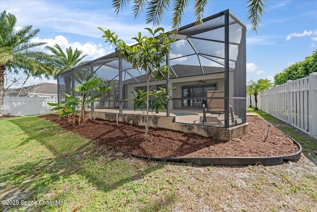 back of house featuring a patio area, a fenced backyard, and a lanai