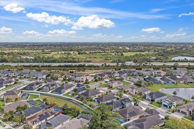 drone / aerial view with a water view and a residential view