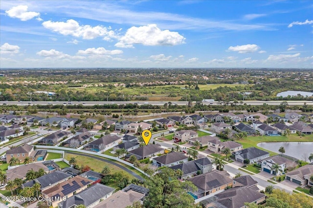 bird's eye view with a water view and a residential view