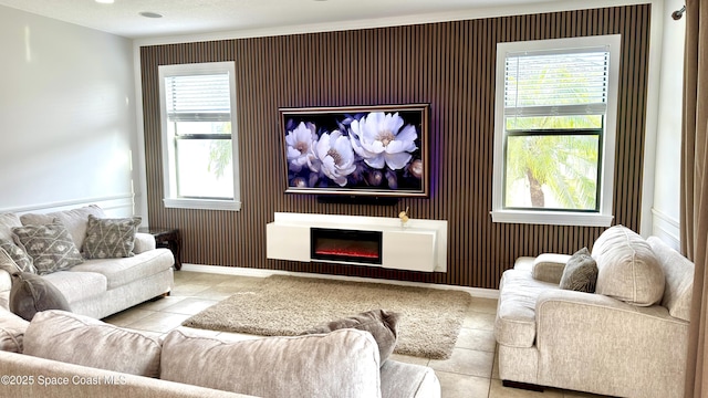 1216 Shiloh Dr, Melbourne, FL 32940 - living room with tile patterned flooring, baseboards, healthy amount of natural light, and a glass covered fireplace