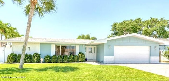 ranch-style home featuring a garage, driveway, and a front yard