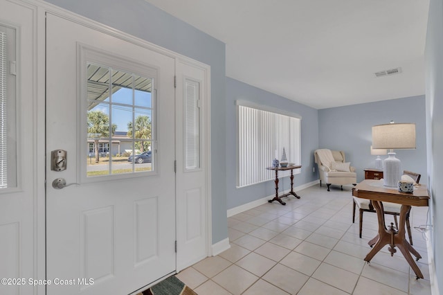 foyer entrance with light tile patterned floors, visible vents, and baseboards