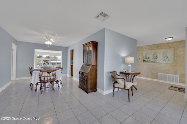 dining space with a ceiling fan, light tile patterned floors, baseboards, and visible vents