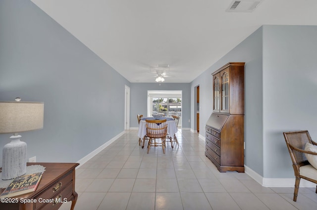 dining space with light tile patterned floors, a ceiling fan, visible vents, and baseboards