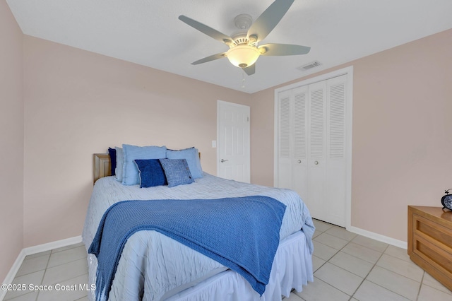 bedroom with light tile patterned floors, a closet, baseboards, and visible vents