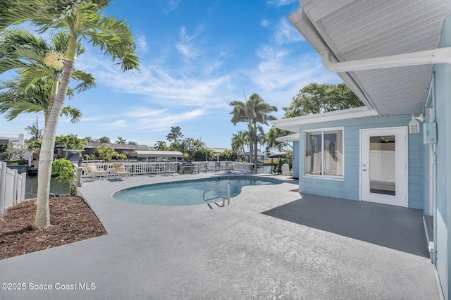 view of swimming pool with a fenced in pool, a patio, and fence