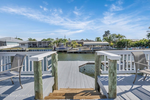 view of dock featuring a residential view and a water view