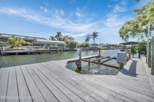 dock area with a water view and boat lift
