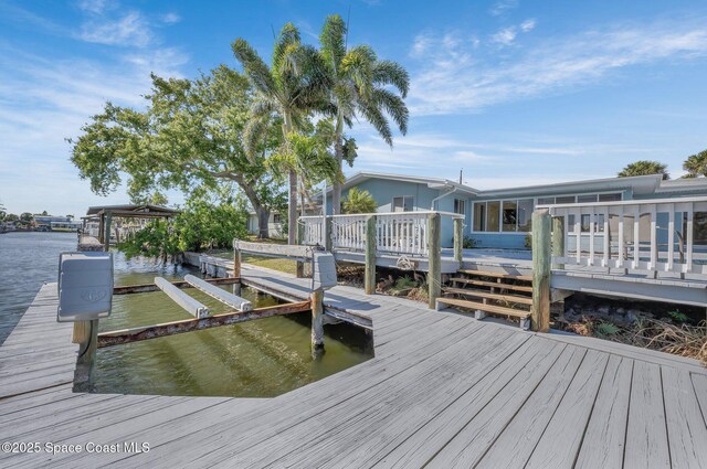 dock area featuring a deck with water view and boat lift