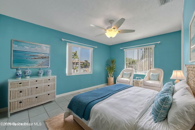 tiled bedroom featuring visible vents, baseboards, and ceiling fan