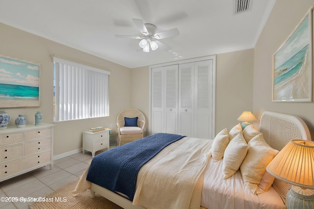 bedroom with light tile patterned floors, a ceiling fan, visible vents, baseboards, and a closet