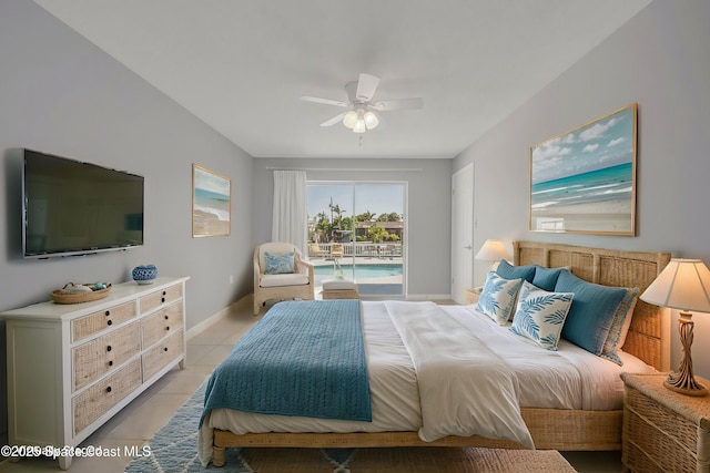 bedroom featuring light tile patterned floors, baseboards, access to exterior, and a ceiling fan