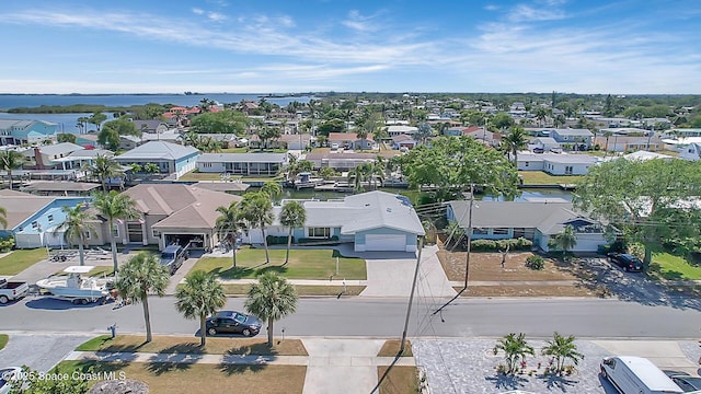 birds eye view of property with a residential view and a water view
