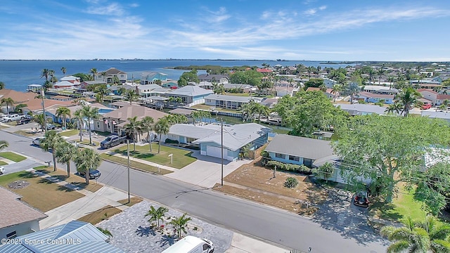 drone / aerial view featuring a residential view and a water view