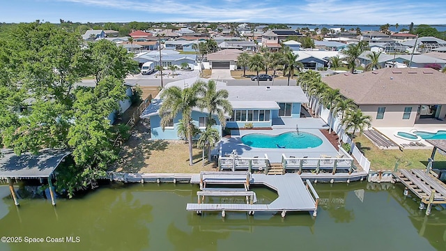 birds eye view of property with a residential view and a water view