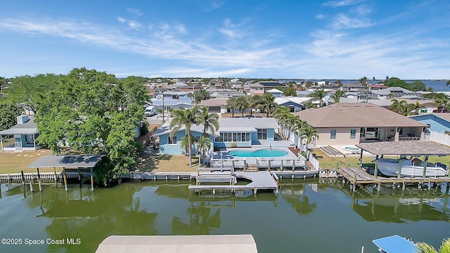 bird's eye view featuring a residential view and a water view