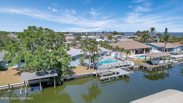 drone / aerial view with a residential view and a water view