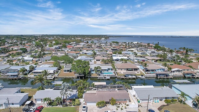 drone / aerial view with a residential view and a water view