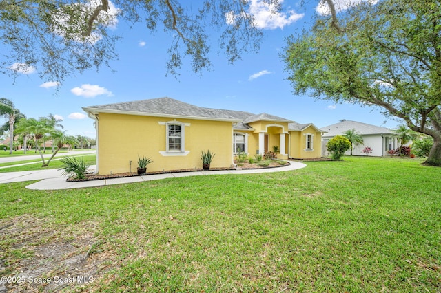 view of front of property featuring a front yard and stucco siding