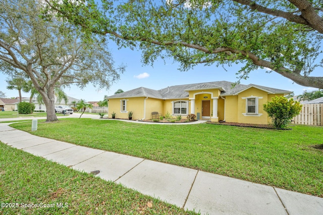 ranch-style home with fence, a front lawn, and stucco siding