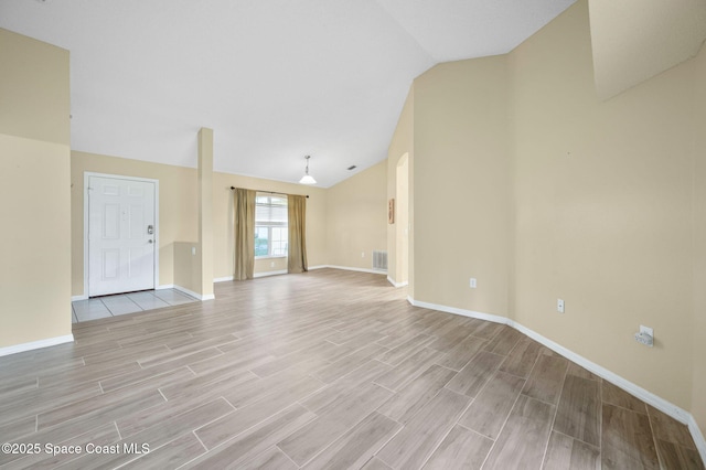 unfurnished living room featuring lofted ceiling, baseboards, visible vents, and wood tiled floor