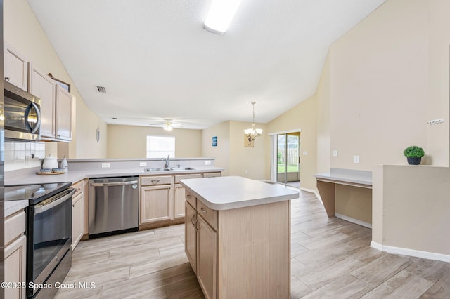 kitchen featuring wood finish floors, a sink, visible vents, light countertops, and appliances with stainless steel finishes