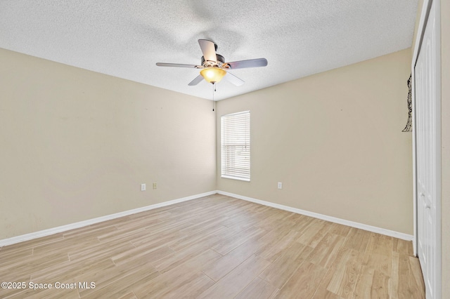 unfurnished bedroom featuring light wood-type flooring, baseboards, and a textured ceiling