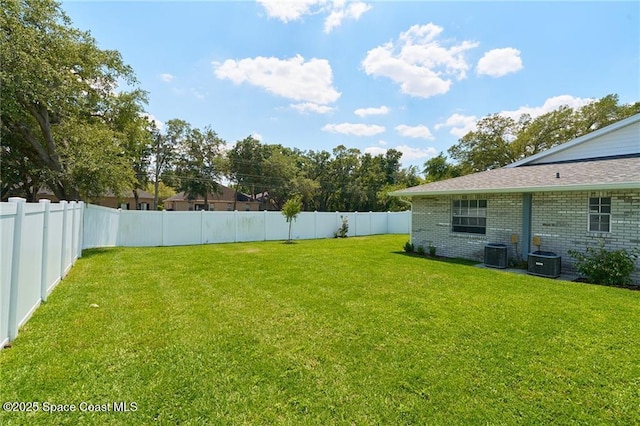 view of yard with central air condition unit and a fenced backyard