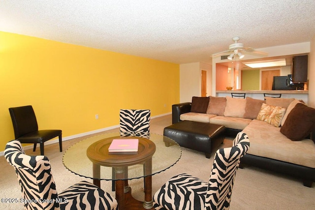 carpeted living area with a textured ceiling and baseboards