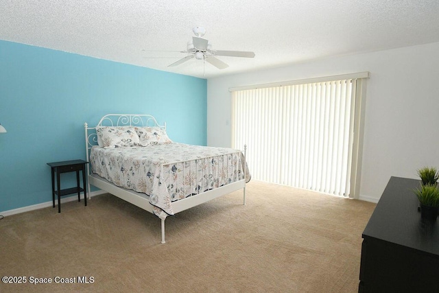 carpeted bedroom with a textured ceiling, ceiling fan, and baseboards