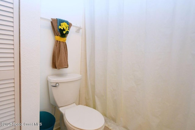 full bathroom featuring curtained shower and toilet