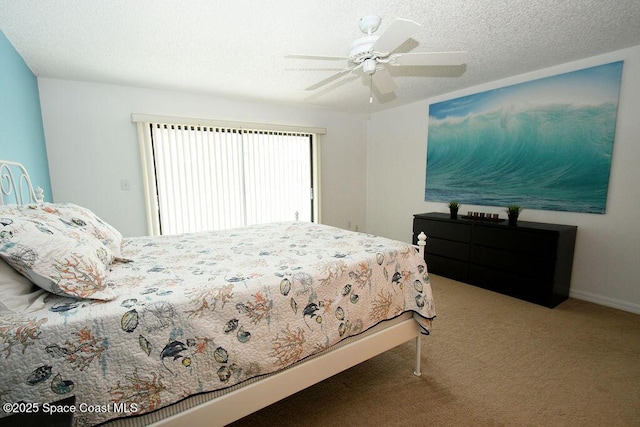 carpeted bedroom with ceiling fan and a textured ceiling