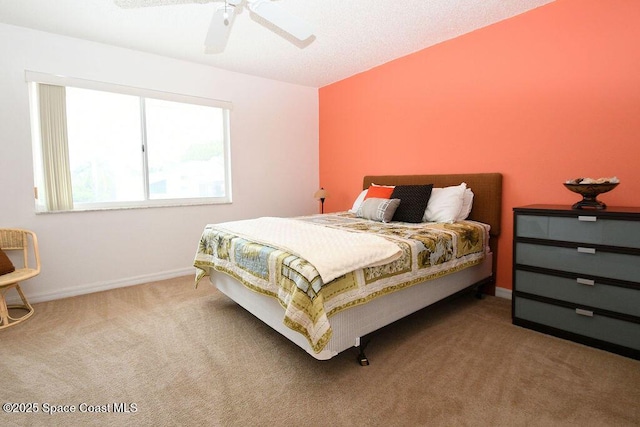 bedroom with a ceiling fan, baseboards, and carpet flooring