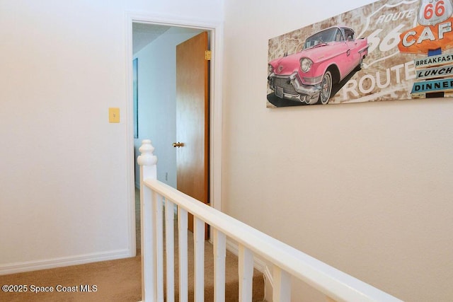 corridor with carpet floors and baseboards