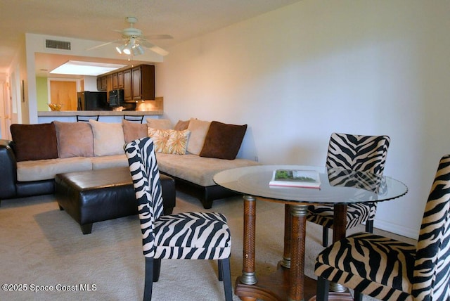 carpeted living area featuring ceiling fan and visible vents