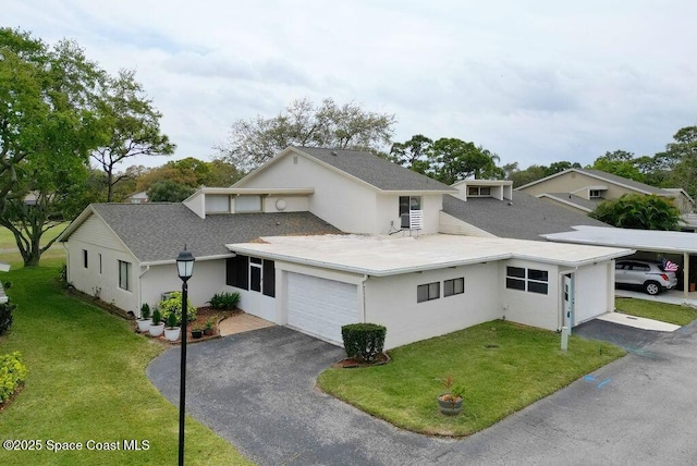 view of front of house featuring a garage, driveway, a front lawn, and stucco siding