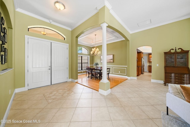 foyer featuring crown molding, arched walkways, and light tile patterned floors