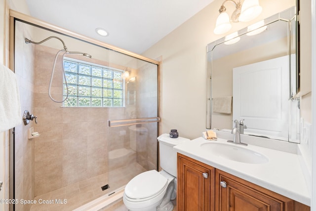 full bath featuring a shower stall, toilet, and vanity